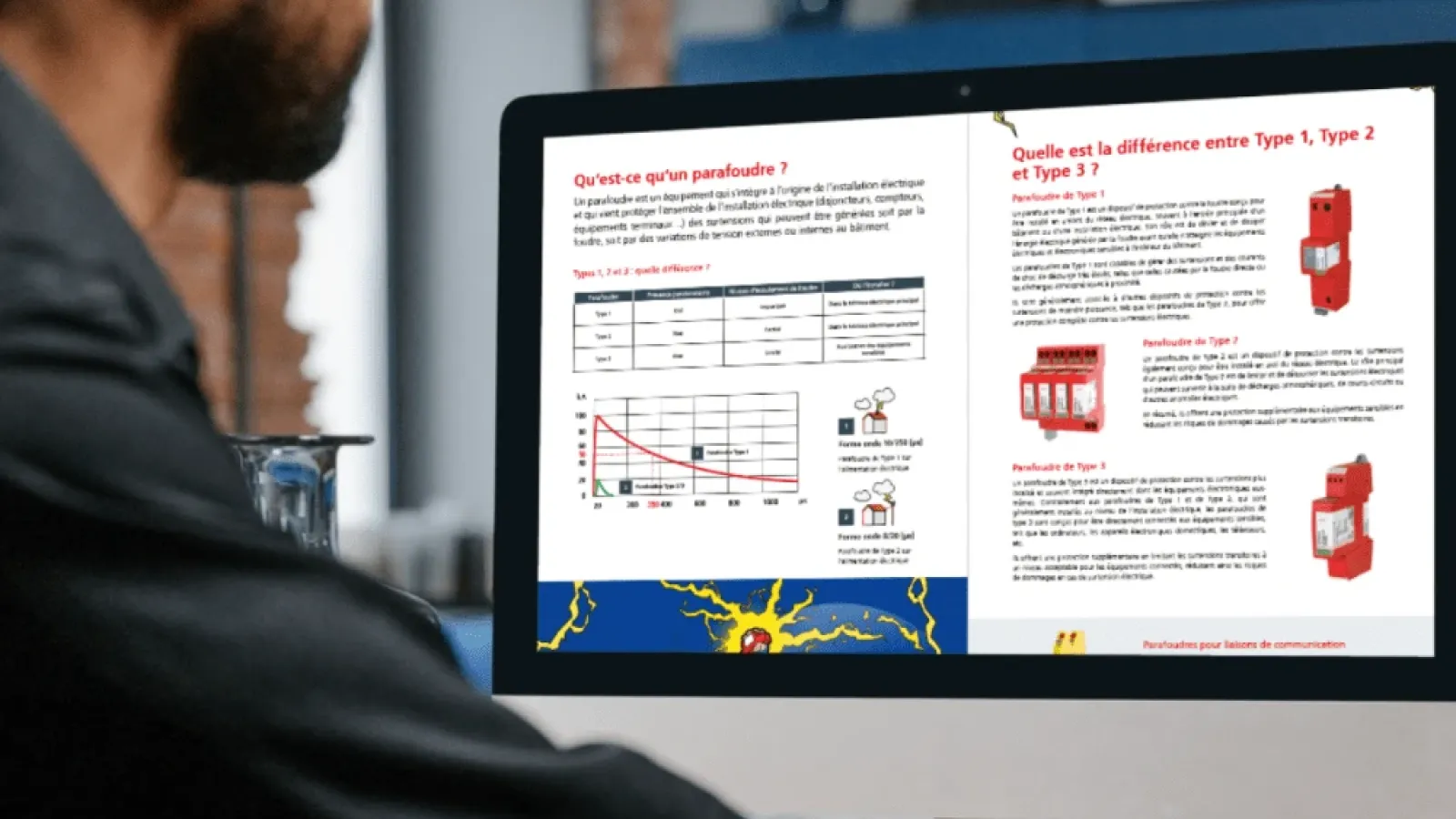 Man viewing guide about surge protection devices on computer screen showing Type 1, Type 2 and Type 3 explanations.