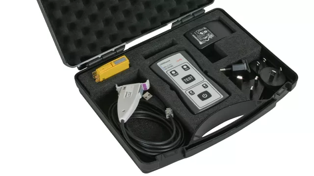 Portable test kit in a foam-lined case containing a handheld tester, cables, adapters and accessories.