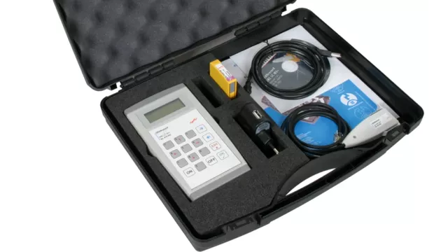 Portable measurement kit in a foam-lined case with a handheld device, cables, adapter, battery and software media.