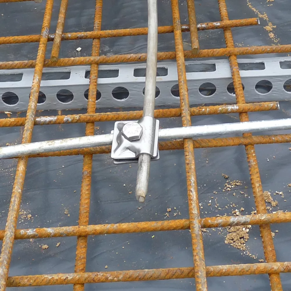 Foundation earthing clamp fixed to rebar grid in concrete slab for building lightning protection system
