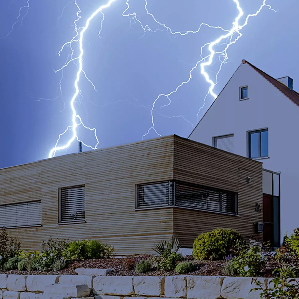 Lightning striking near residential house illustrating need for lightning protection and surge protection system