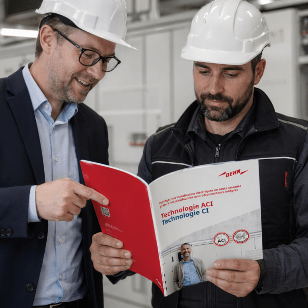 Installer and sales looking at a brochure with ACI technology, CI technology and SPDs