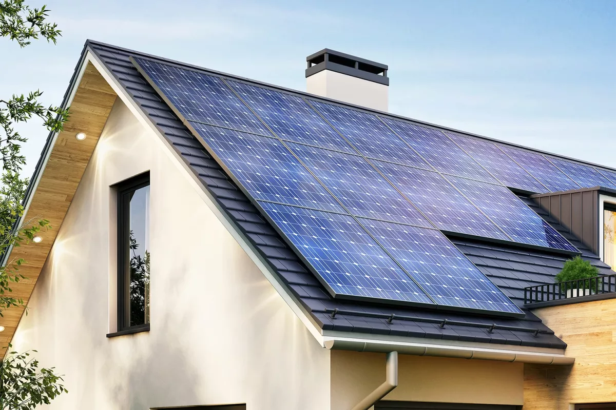 A captivating image displays a sleek, modern house with a striking black roof, donning a vibrant blue solar panel. The large window on the left and chimney on the right create a warm contrast, as lush greenery surrounds the eco-friendly abode, inviting natures beauty into view.